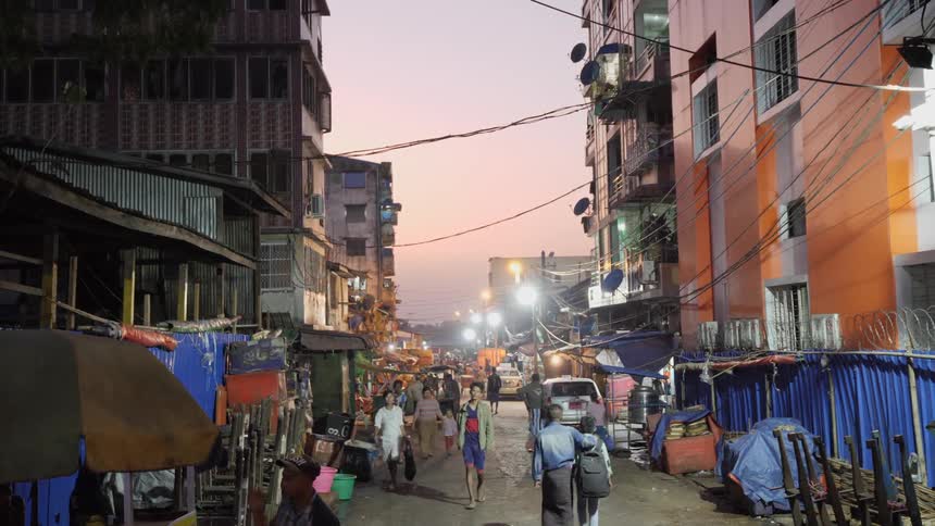 People and vehicles travel along a city road