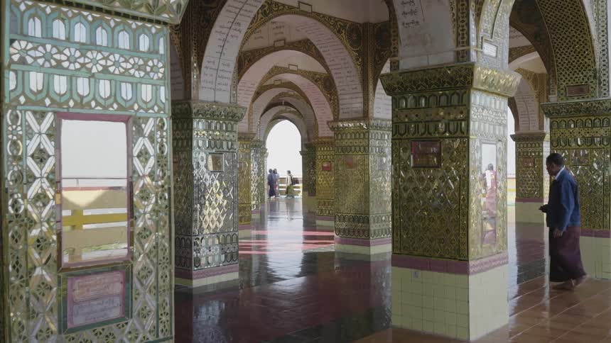 People walk through an ornate building