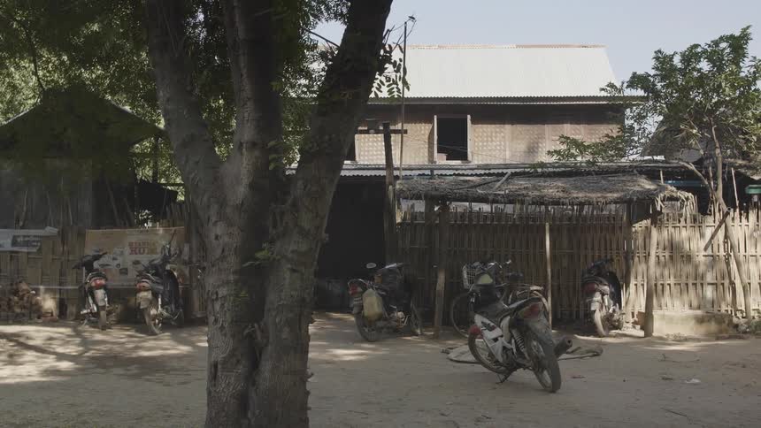 Motorcycles are parked next to a building