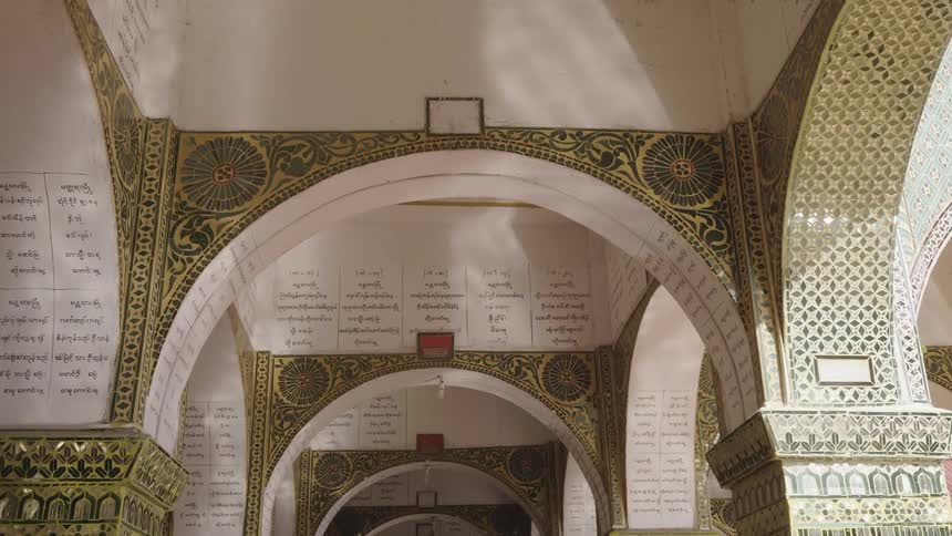 A corridor with several arches covered in artwork