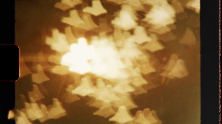 Out of focus sun through tree leaves on vintage film