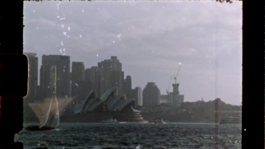 Boats sail by the sydney opera house