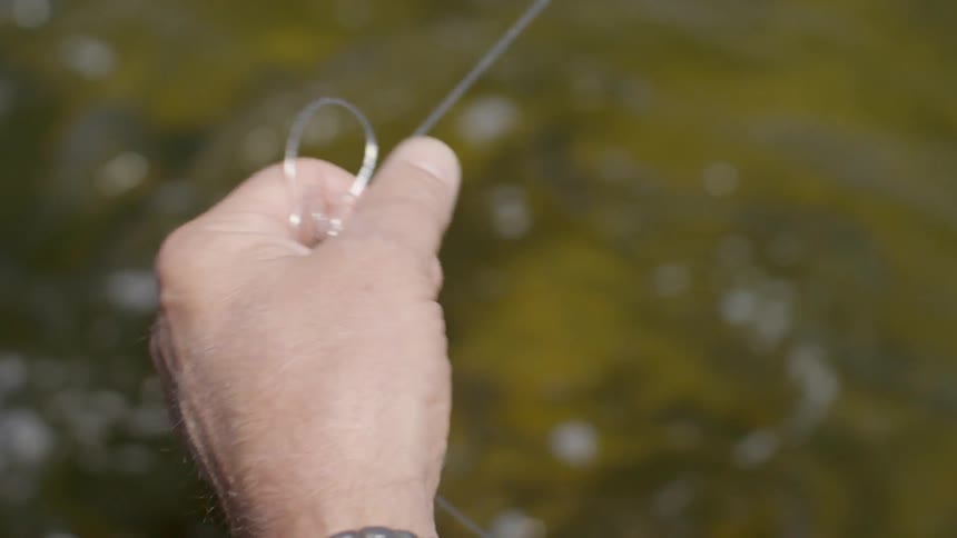 A man twisting fishing line up in his hand