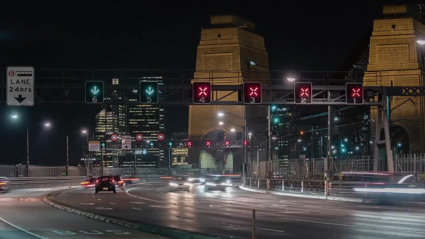 Traffic on a city highway traveling in both directions creates streaks of light at night
