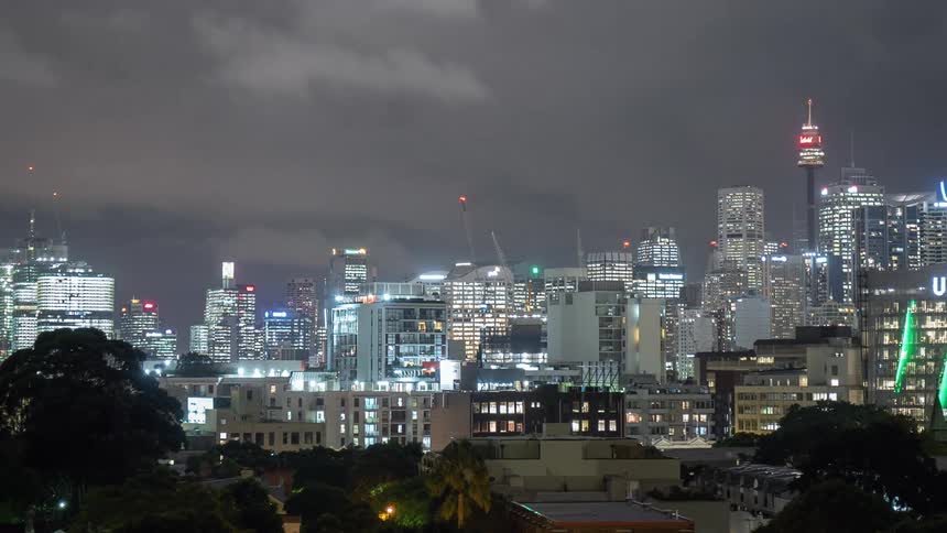 Aerial view of city with tall buildings and skyscrapers at night