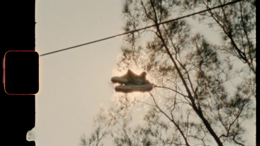 Shoes hang from a power line 8mm film