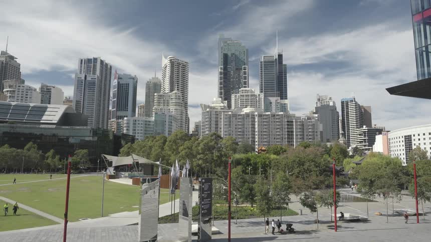 Students walk around campus with near city skyline