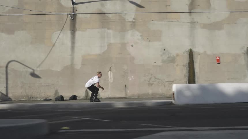Man move along the road using roller skates