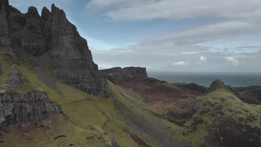 A rocky cliff and canyon with the sky in the background