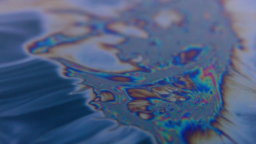 Close up of oil mixing with water