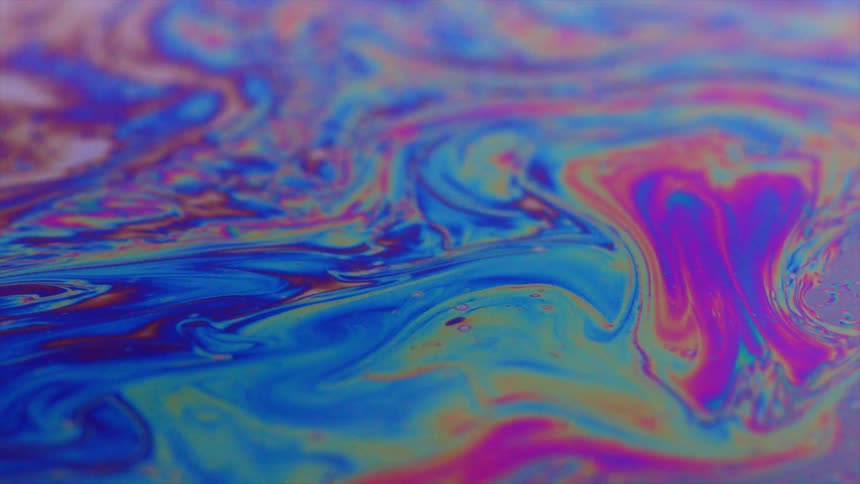 Beautiful bands of color in oil layer floating on water