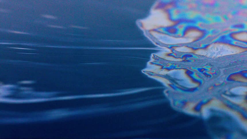 A colorful liquid moving across a surface