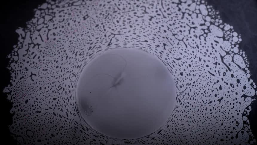 An ink bubble becomes larger in a sea of ink