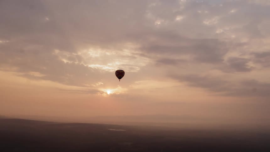 A hot air balloon moving through the sky