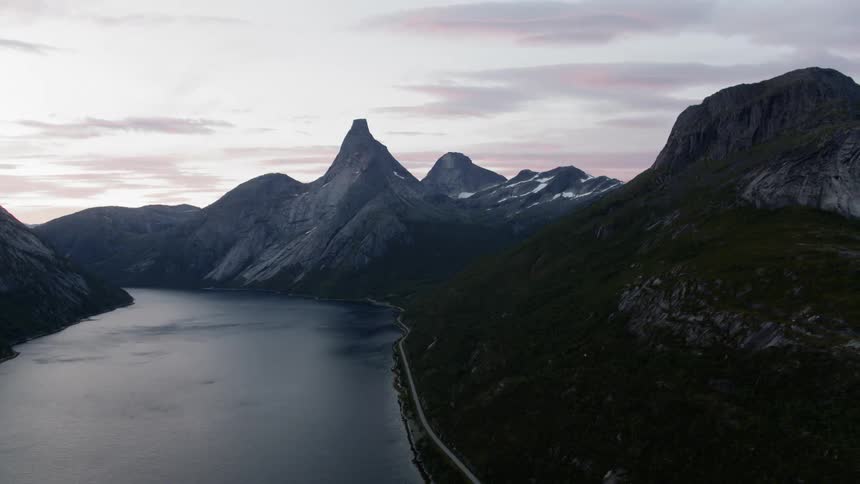 The fjord flows near Norwegian mountains