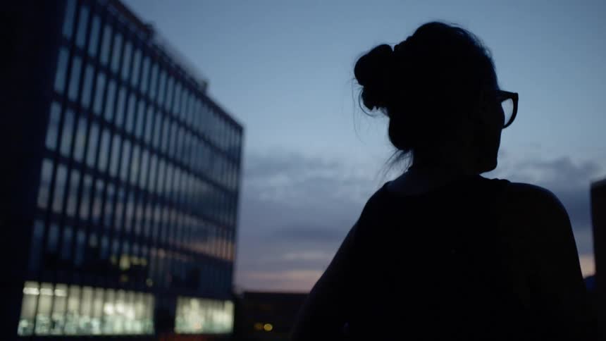 A woman looks out over a city