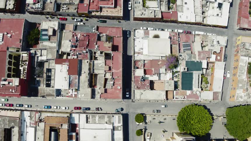 Aerial of cars driving through residential neighborhoods in the city