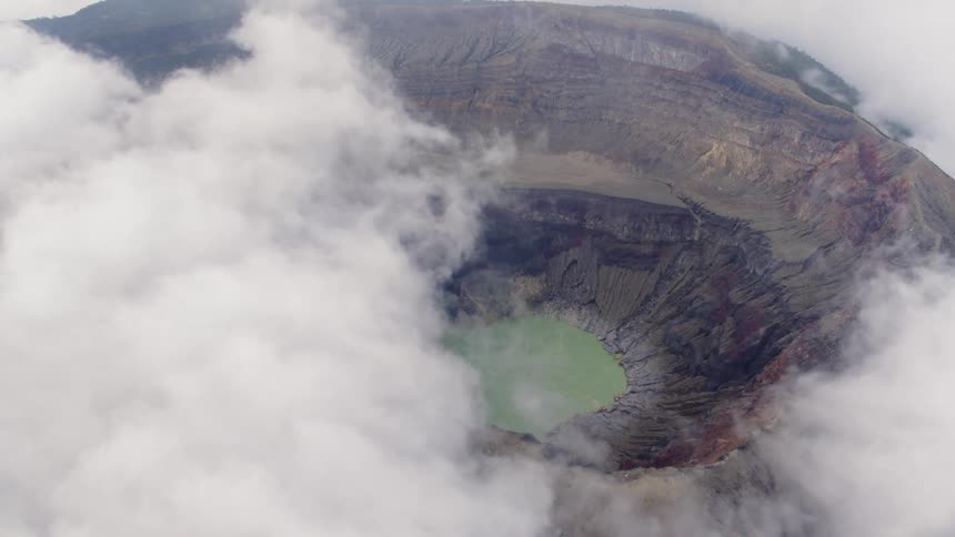 Clouds float over a volcano crater