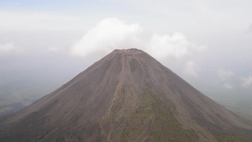 A volcano with clouds in background