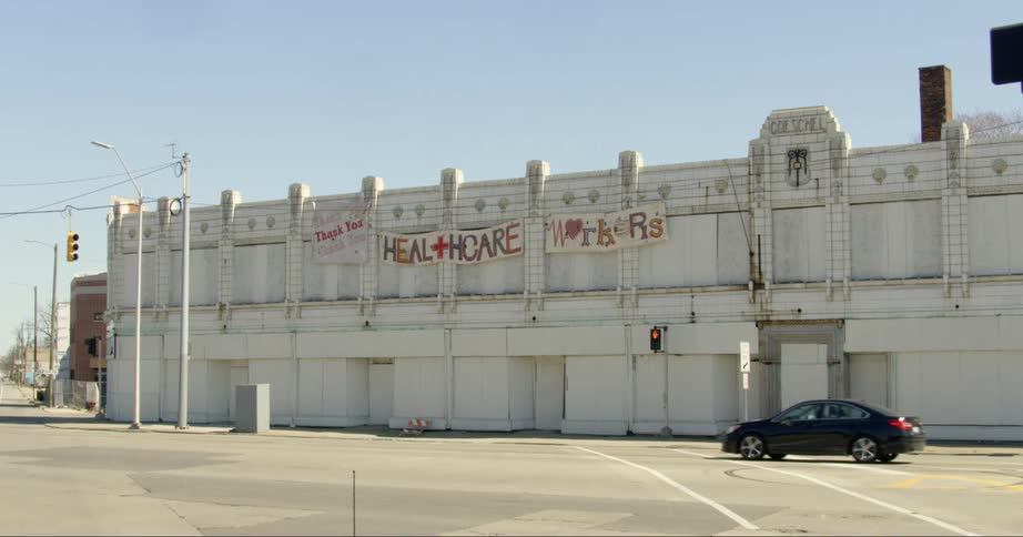 A static shot of a building with signs for healthcare workers