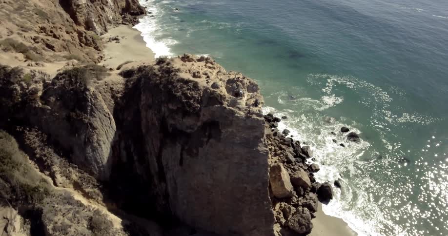 Waves crash against rocks on the shore