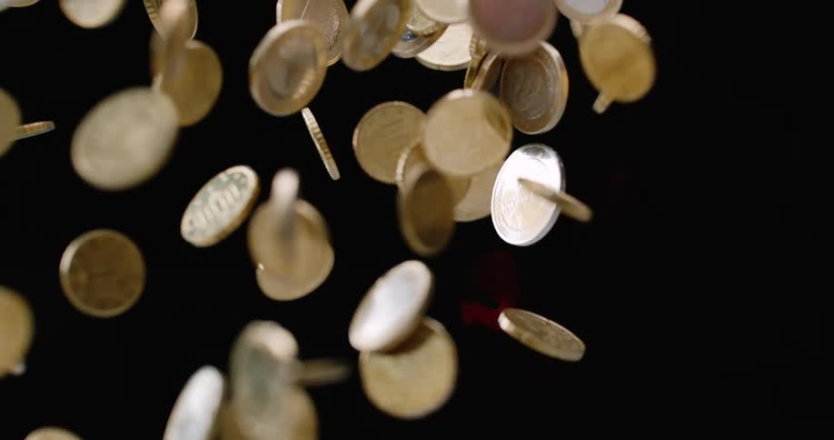 Coins being tossed up and then falling down