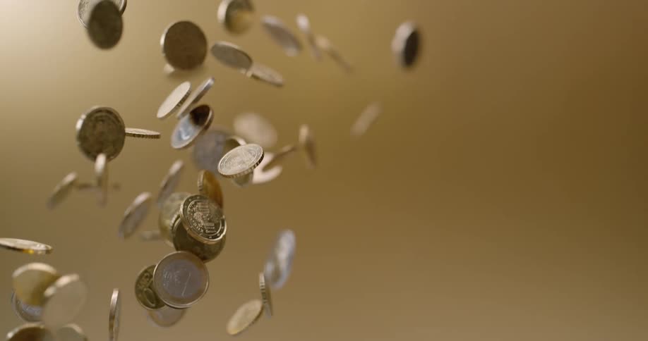 Coins thrown in the air fall to the ground