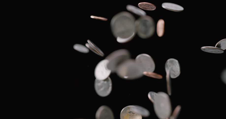 Coins flying up in the air fall back down