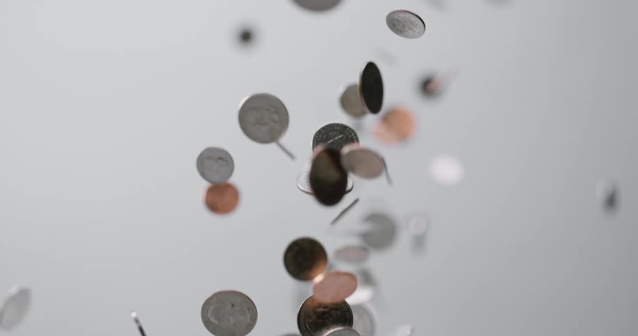 A number of coins going up and then down through the air