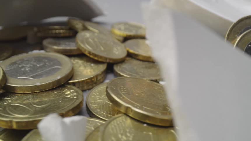 Hammer broken piggy bank box and scattered coins