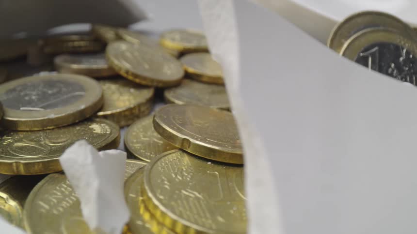 Currency sitting on a table with pieces of rock
