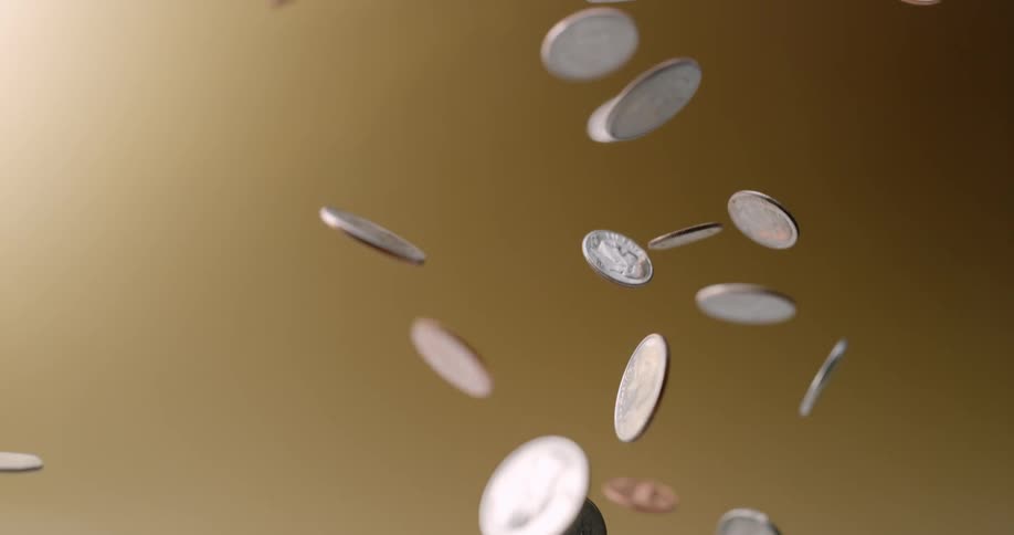 Coins being thrown in the air in slow motion