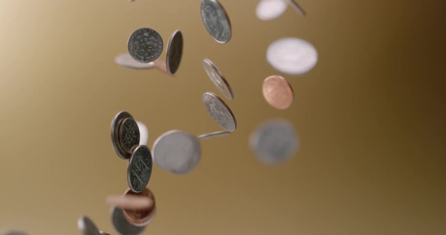 Various coin denominations fly through the air