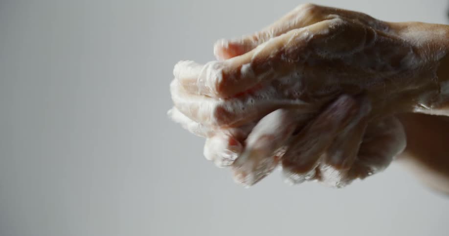 A woman washes her fingers and hands thoroughly