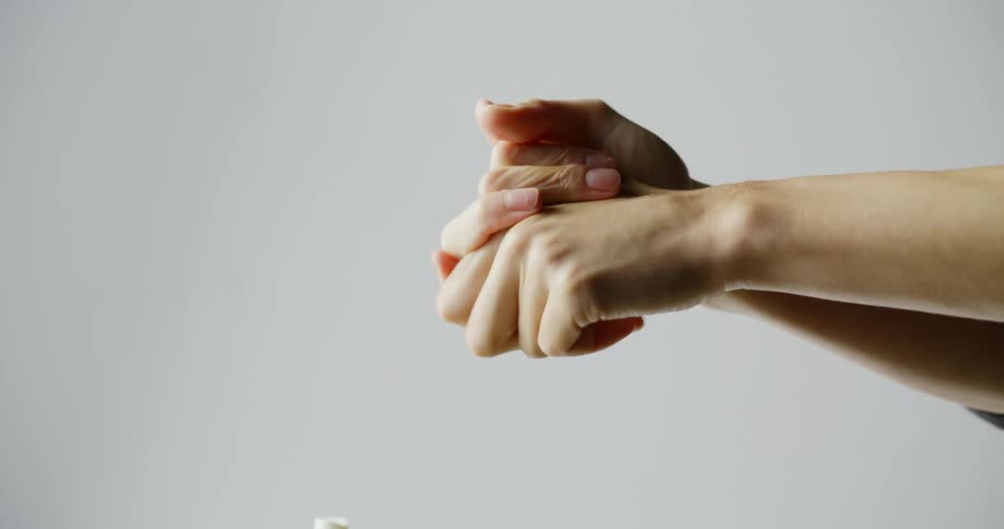 A white man rubs his hands together