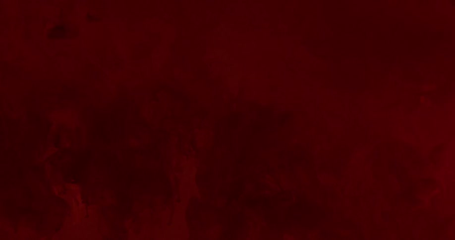 Red textured liquid swirls and spreads into clear liquid