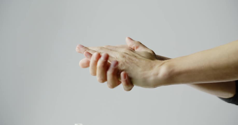Woman washing hands with hand sanitizer