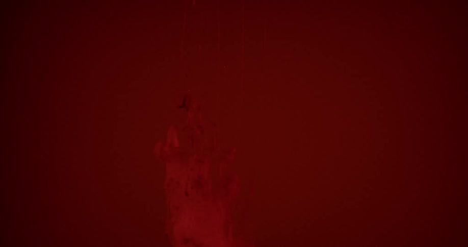 Red liquid is being poured