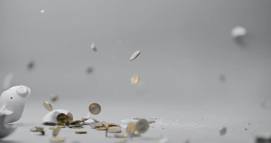 A white person smashes a ceramic piggy bank with a hammer