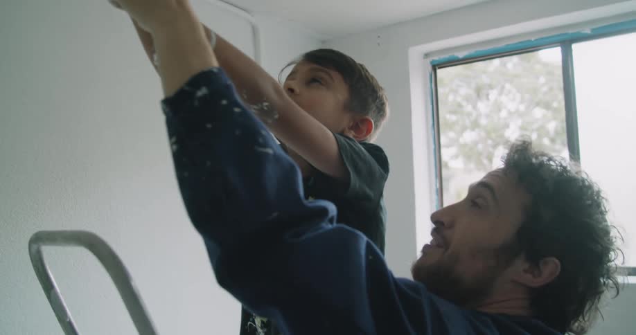 A father and son painting a room