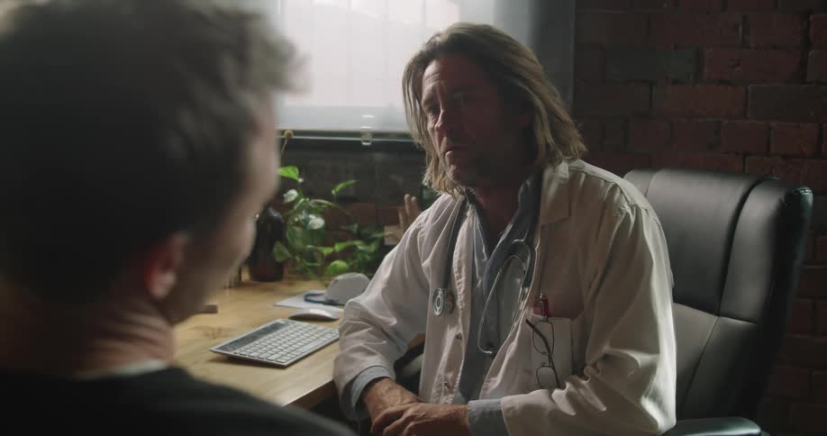 A man describes his neck pain to his doctor