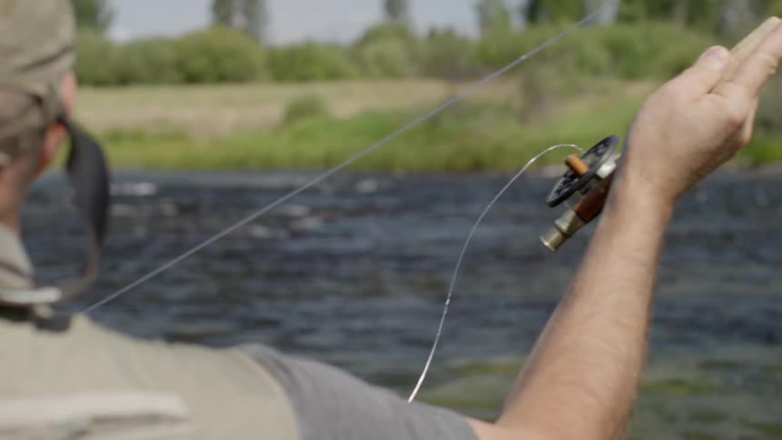 A man fly-fishing in a river
