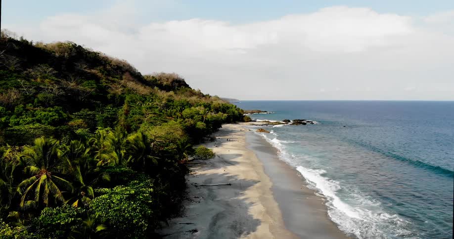 Ocean waves crash against the secluded beach