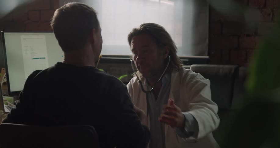 The doctor listens to the patients heart