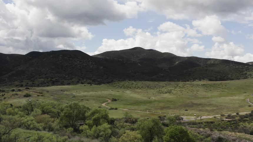 A road snakes through a large expanse of grassland