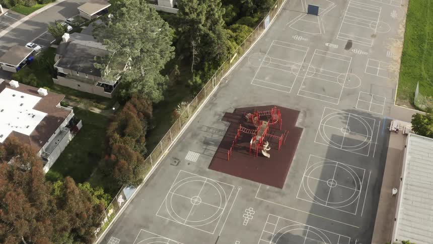 A playground sits in the middle of a number of sport courts
