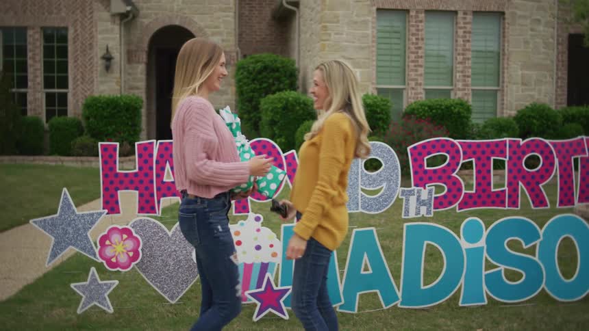 Blonde women cuddle each other to celebrate birthday outdoors