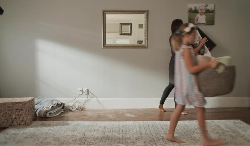 A mother and her daughter remove objects from a living room