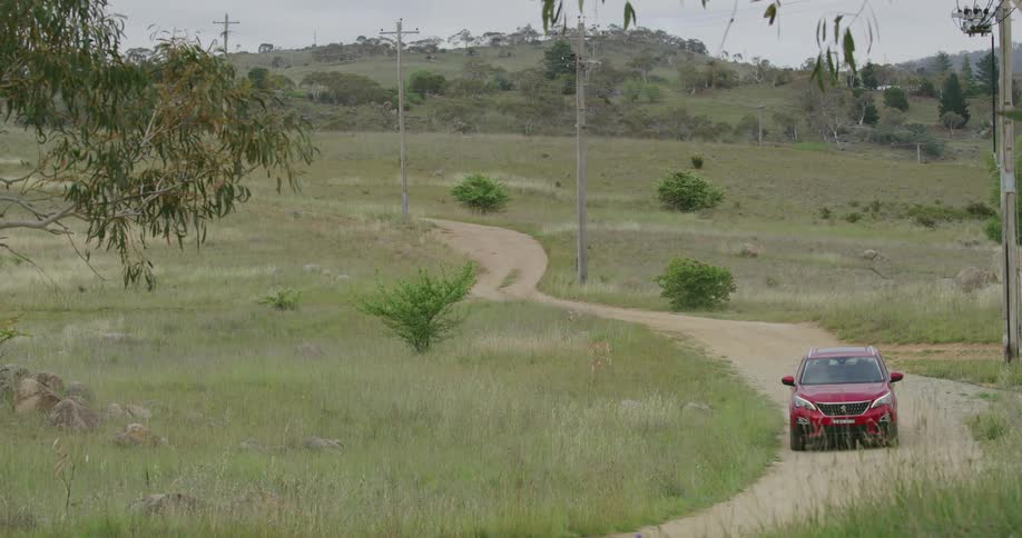 A vehicle driving on a dirt road