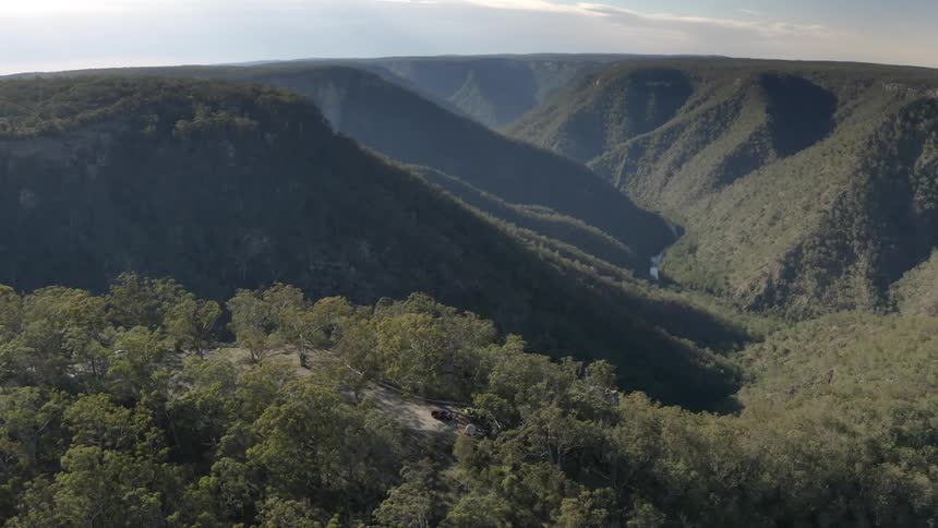 Car parks in road atop of mountains surrounded by forests